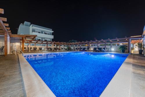 a large swimming pool in a hotel at night at Aparthotel Plat in Kožino