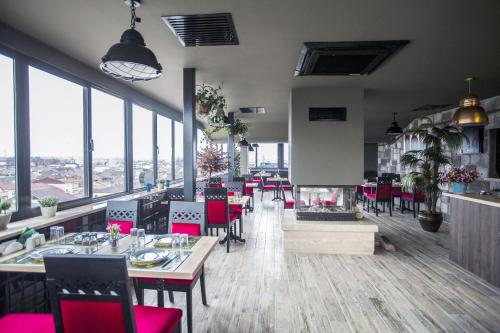 restauracja ze stołami i krzesłami oraz kominkiem w obiekcie RİVADA HOTEL w mieście Kartepe