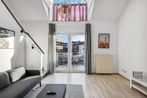 a living room with a couch and a table at Galeriewohnung im Zentrum Worms! in Worms