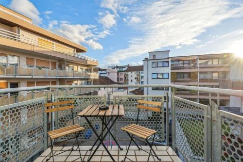 a balcony with two chairs and a table at Galeriewohnung im Zentrum Worms! in Worms