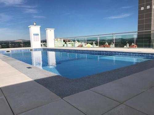 a swimming pool on top of a building at Superb 2 Bed apartment with Roof Top Pool, close to Falesia Beach AT10 in Albufeira