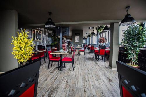 a dining room with tables and red chairs at RİVADA HOTEL in Kartepe