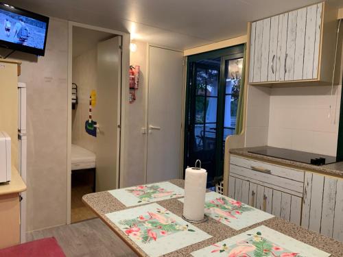 a kitchen with a table with a candle on it at Privlaka Mobilhouses in Privlaka