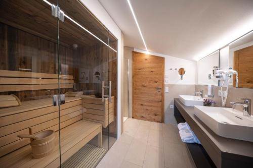 a bathroom with a sink and a shower at Lakeside Luxury Apartments in Zell am See