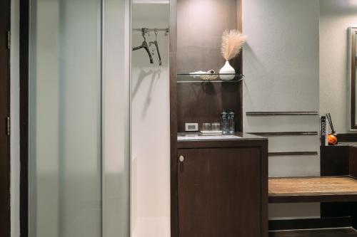 a bathroom with a sink and a shower with a towel at Tori crown hotel in Bangkok