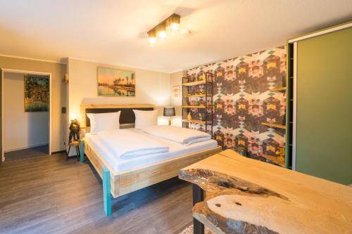 a bedroom with a bed and a wall with a mural at Design Apartments - "Remise Blumberg" in Potsdam