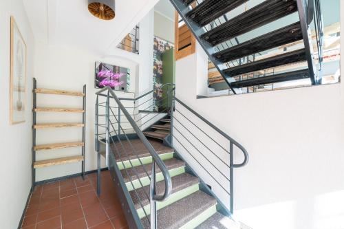 a winding staircase in a home with white walls and a stair case at Design Apartments - "Remise Blumberg" in Potsdam