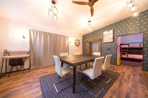 a dining room with a table and chairs and a bed at Design Apartments - "Remise Blumberg" in Potsdam