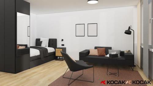 a bedroom with a bed and a couch and a chair at KOCAK - Exklusives Apartment im Zentrum in Reutlingen