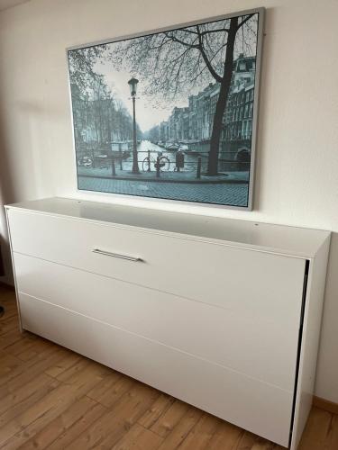 a white dresser with a tv on top of it at Apartment 540, Oberharz, mit Schwimmbad und Sauna in Braunlage
