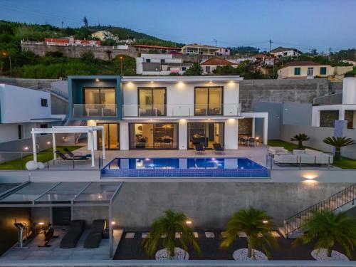 a villa with a swimming pool at night at Villa Boa Nova Preta by LovelyStay in Funchal