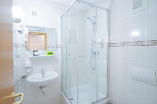 a bathroom with a shower and a sink at Ferien Hotel Spreewald in Kolkwitz