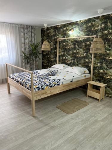 a bed in a bedroom with a wall at Ca acasă Corbu in Corbu
