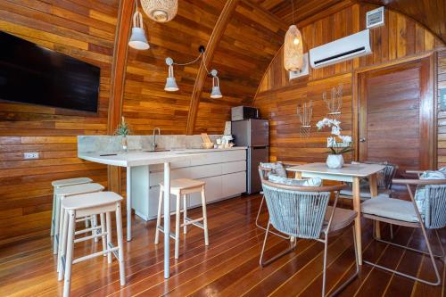 a kitchen and dining room with wooden walls at Tropical Chalet 2BR Villa Pasak Paradise 1 with Private Pool, Laguna 10 min drive in Ban Pak Lak