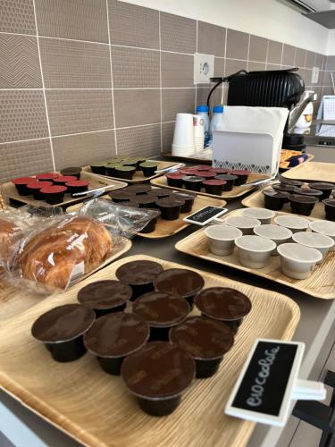 a counter topped with lots of brownies and cupcakes at Ferriera 8 in Novi Ligure