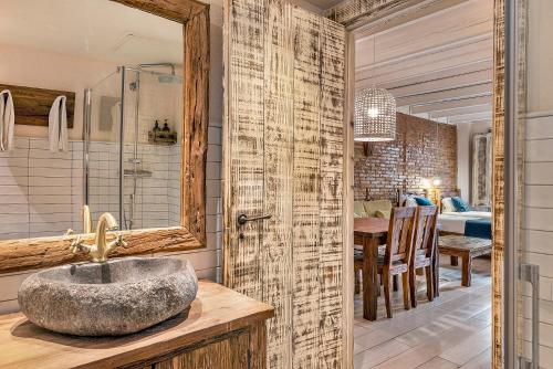 een badkamer met een wastafel en een spiegel bij La Bodega Suites in Hospitalet de Llobregat