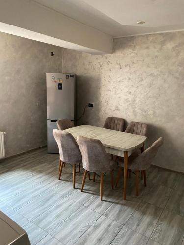 a kitchen with a table and chairs and a refrigerator at WRW Center in Bistriţa