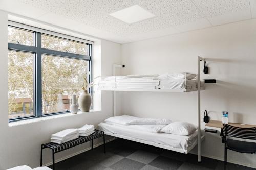 a bedroom with two bunk beds and a window at Sportium Sportel in Varde