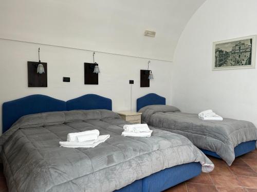 a bedroom with two beds with towels on them at B&B Centro Storico in Caltanissetta