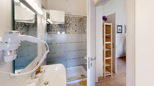 a bathroom with a sink and a mirror at GUEST HOUSE SONNINO 37 in Cagliari