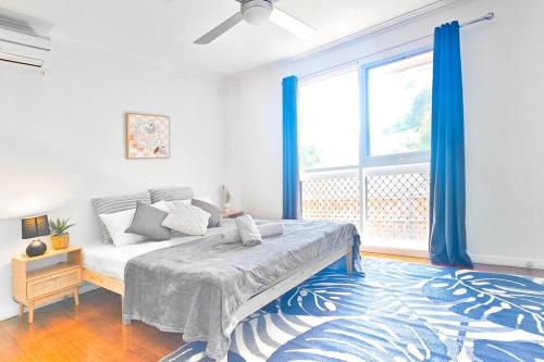 a bedroom with a bed and a large window at Mel Eastern Villa near everything in Doncaster East