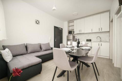 a living room with a couch and a table with chairs at Apartment Stefanio in Vodice