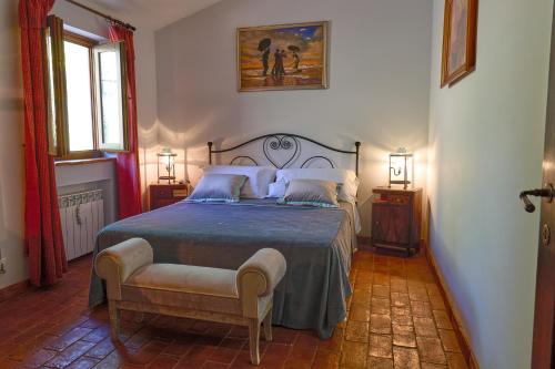 a bedroom with a bed with a blue comforter at Borgodoro - Natural Retreat in Magliano Sabina