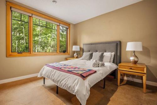 a bedroom with a bed with two stuffed animals on it at Escape to the Rockies but near Calgary Includes Free Parking and Banff Entry in Calgary