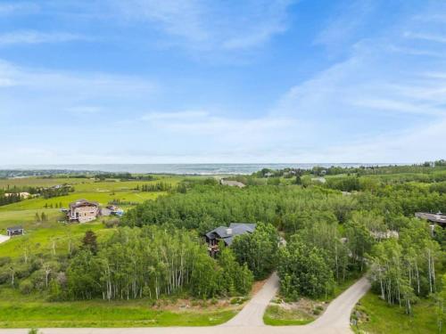 an aerial view of a house on a hill with trees at Escape to the Rockies but near Calgary Includes Free Parking and Banff Entry in Calgary