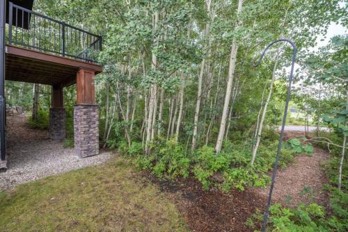 a porch of a house with a forest of trees at Escape to the Rockies but near Calgary Includes Free Parking and Banff Entry in Calgary