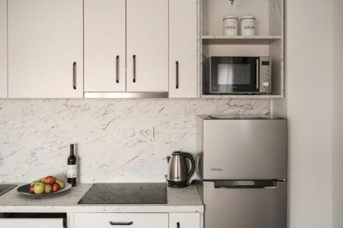 a kitchen with a refrigerator and a bowl of fruit at Apartment Stefanio in Vodice