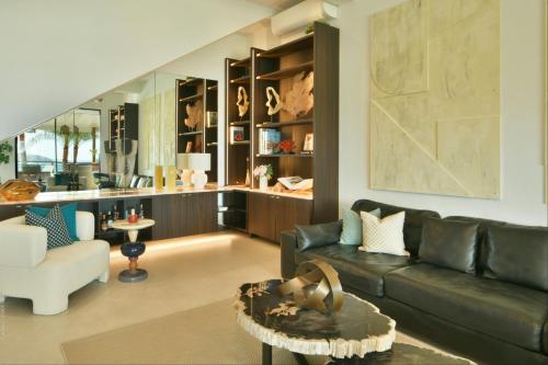 a living room with a couch and a table at Villa Nagabaaja near Anse des Cayes - 230 m² with pool in Anse des Cayes