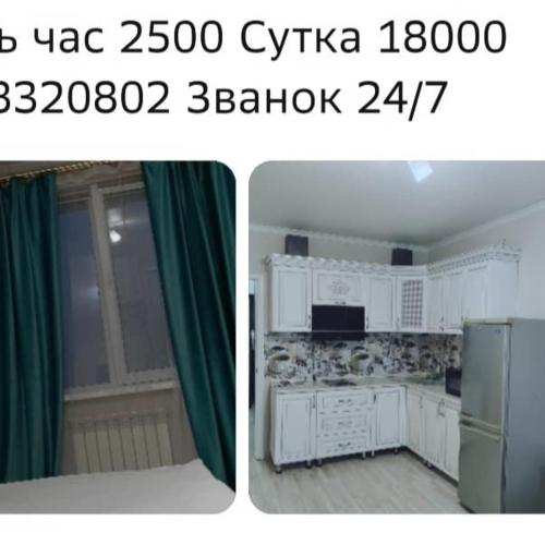 a kitchen with white cabinets and a green curtain at ЖК Молодежный in Almaty