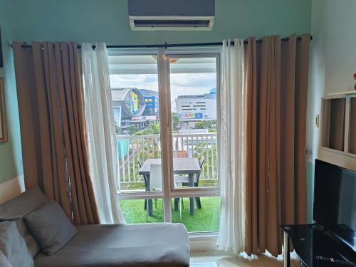 a living room with a large window with a view at Premiere Haven MOA Staycation in Manila
