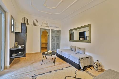 a living room with a bed and a mirror at Riad Al Badia in Marrakesh