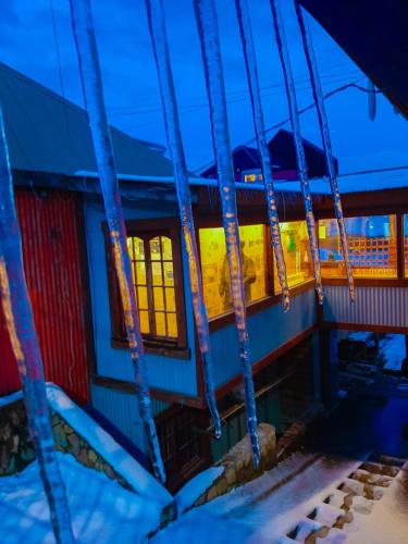 a building with lights in the windows at night at Hostel Cruz del Sur in Ushuaia