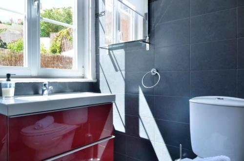 a bathroom with a toilet and a sink and a window at Lightoasis Oeiras 1 in Oeiras