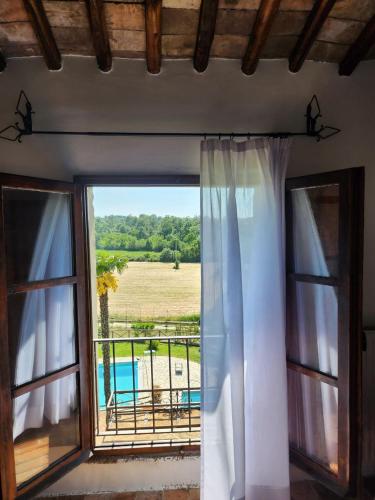 a room with a window with a view of a field at Villa Arzilla Antica Residenza di campagna in Vitorchiano