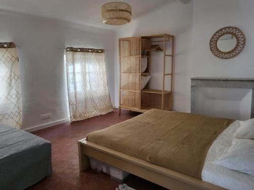 a bedroom with a bed and a mirror on the wall at Logement au coeur de Marseille, le Stassi in Marseille