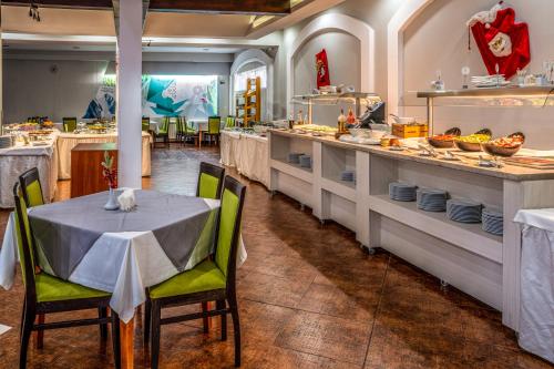 a restaurant with a table and chairs in a kitchen at MPM Hotel Guinness in Bansko