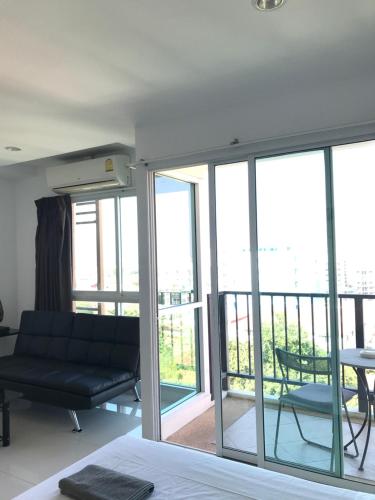a living room with a couch and a balcony at Diamond Suite in Pattaya South
