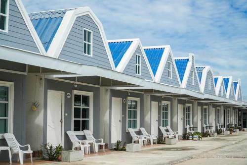 a row of houses with solar panels on them at Preme village in Ubon Ratchathani