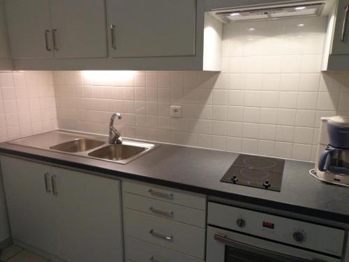 a kitchen with a sink and a counter top at Arbousiers in Morcenx