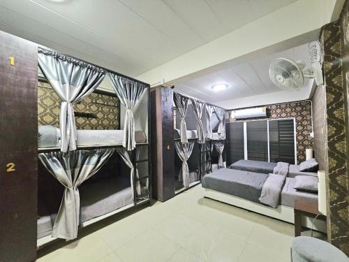 a bedroom with two bunk beds and curtains at Future Hostel Pattaya in Nong Prue