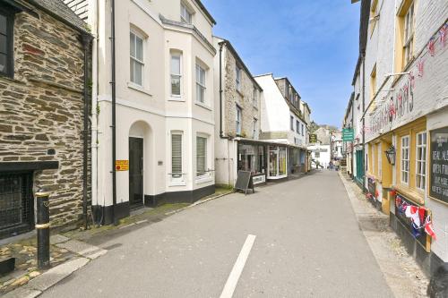 an empty street in a city with buildings at Captain's House Looe in Looe
