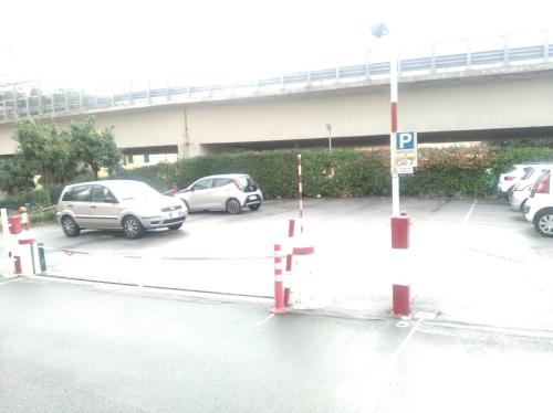 um parque de estacionamento com vários carros estacionados nele em Stanza matrimoniale con balcone em Gênova