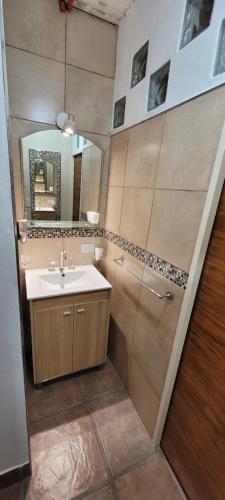 a bathroom with a sink and a mirror at Quincho Isabella in Bella Vista