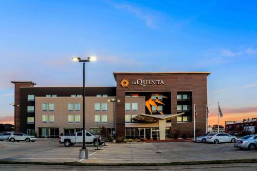 a hotel with a sign on the front of a building at La Quinta by Wyndham Houston Cypress in Cypress