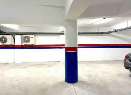 a parking garage with red white and blue columns at Studio neuf confort bien placer in Casablanca