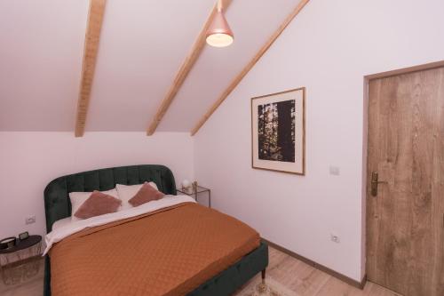 a bedroom with a bed and a wooden door at Cabana Luna in Valea Ierii